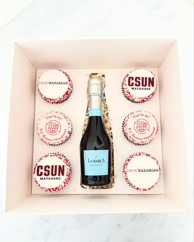 Gift box of CSUN graduation cupcakes arranged around a bottle of prosecco
